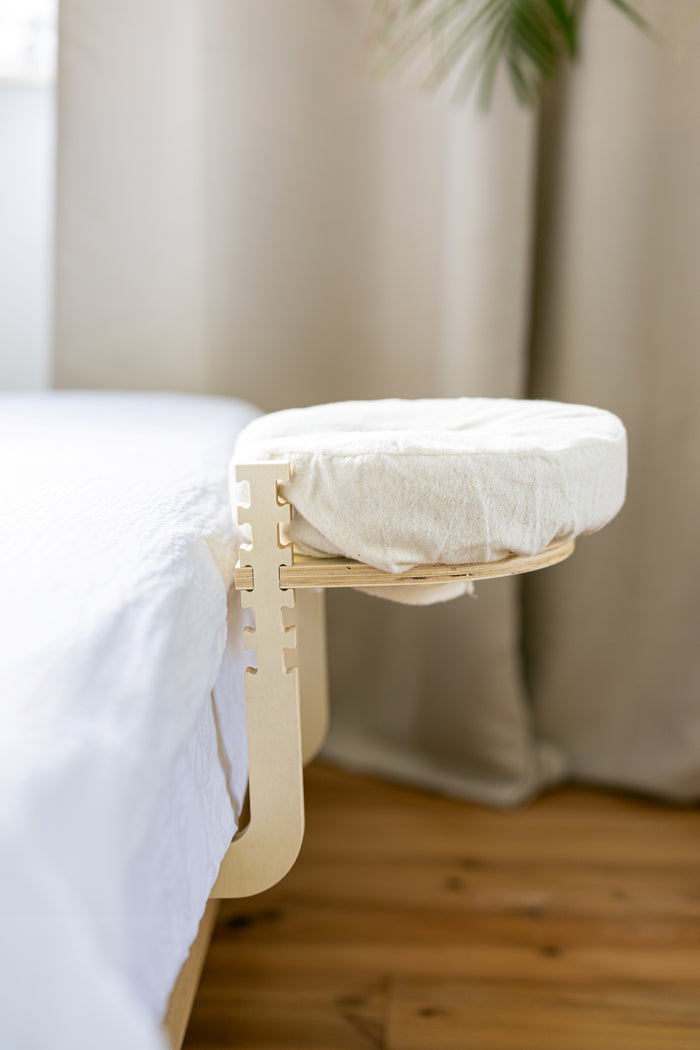 The set standing ready at the edge of a bed