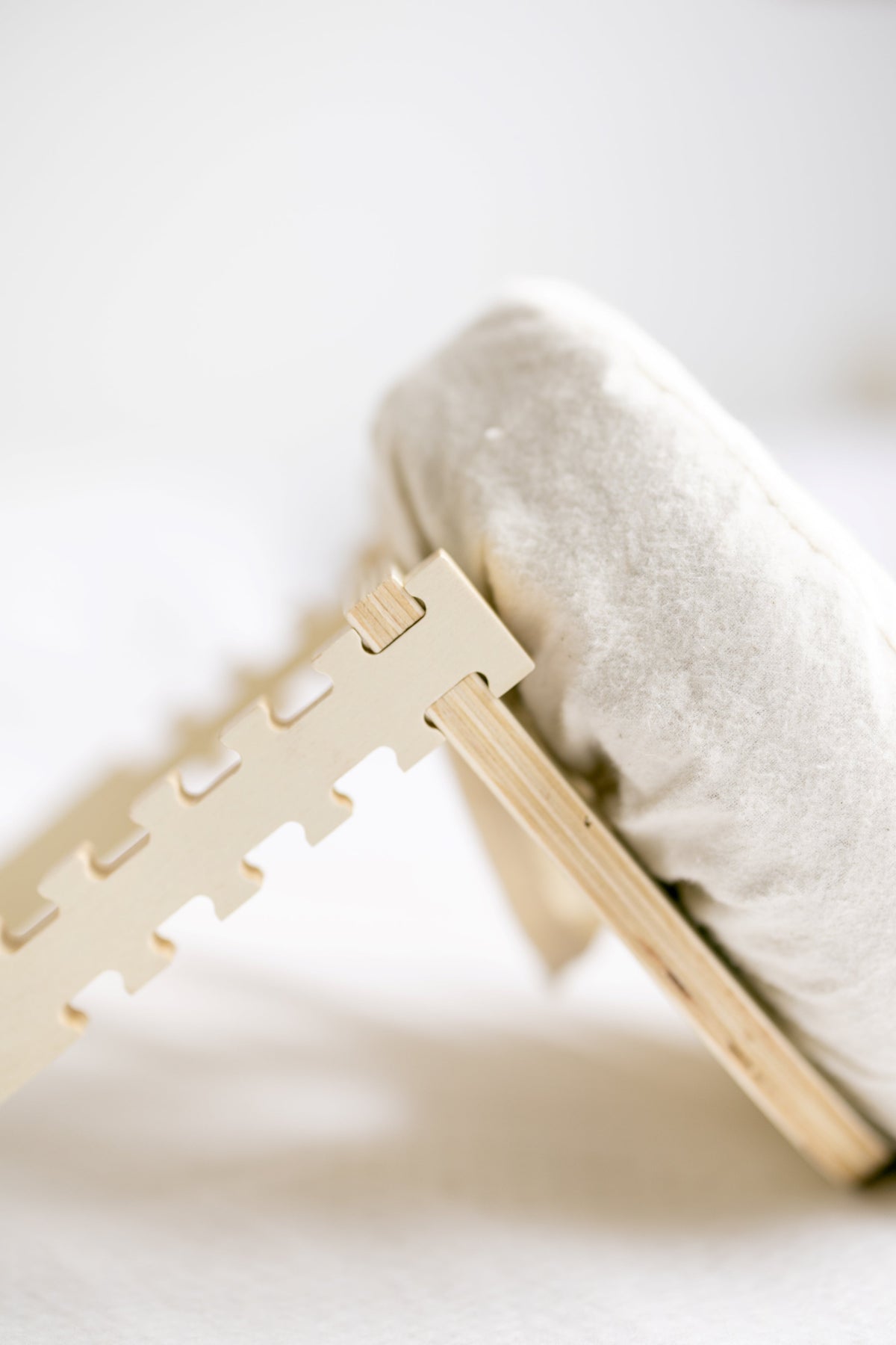 The wooden frame close up at the edge of a mattress