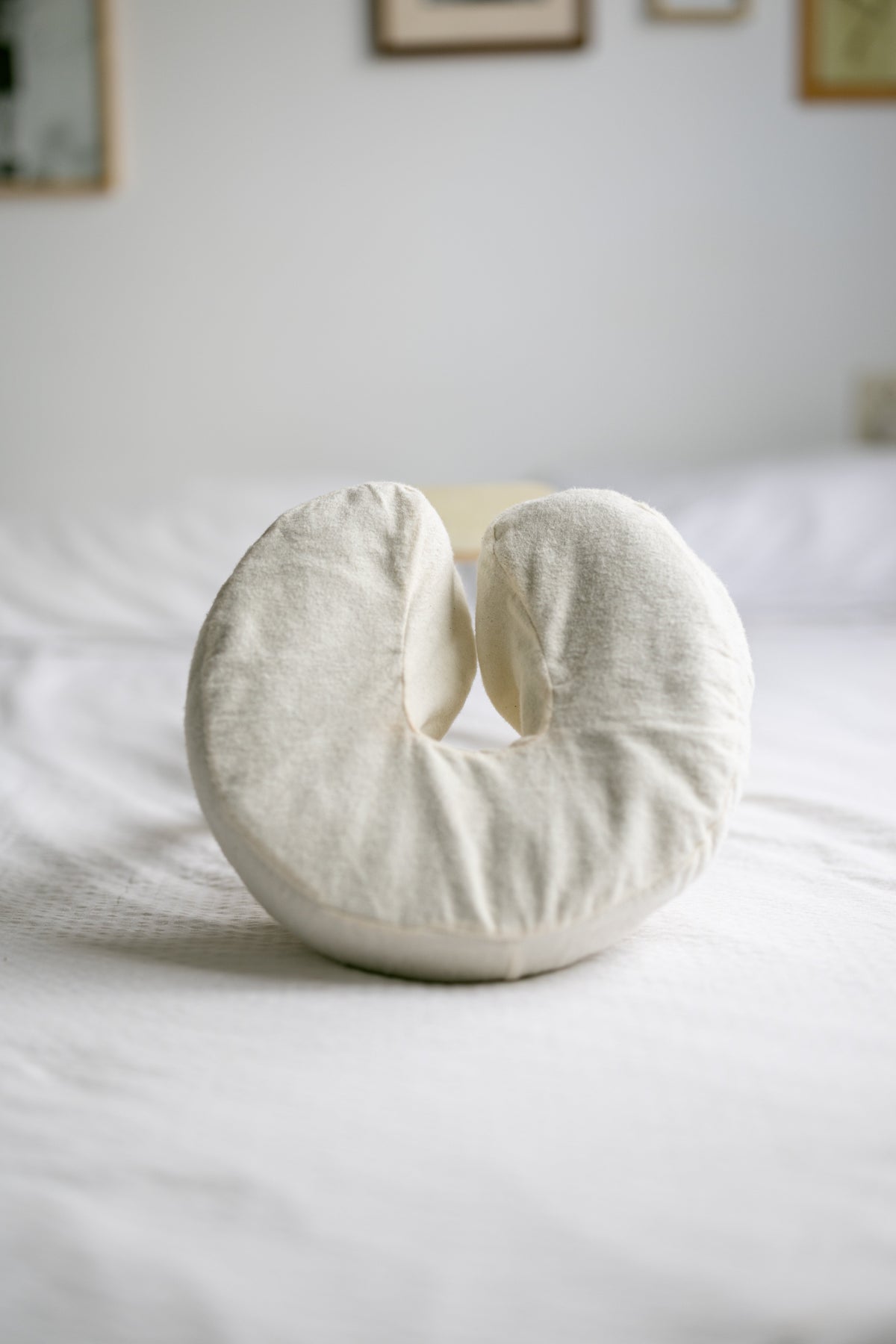 The head cushion with cotton cover on a made bed