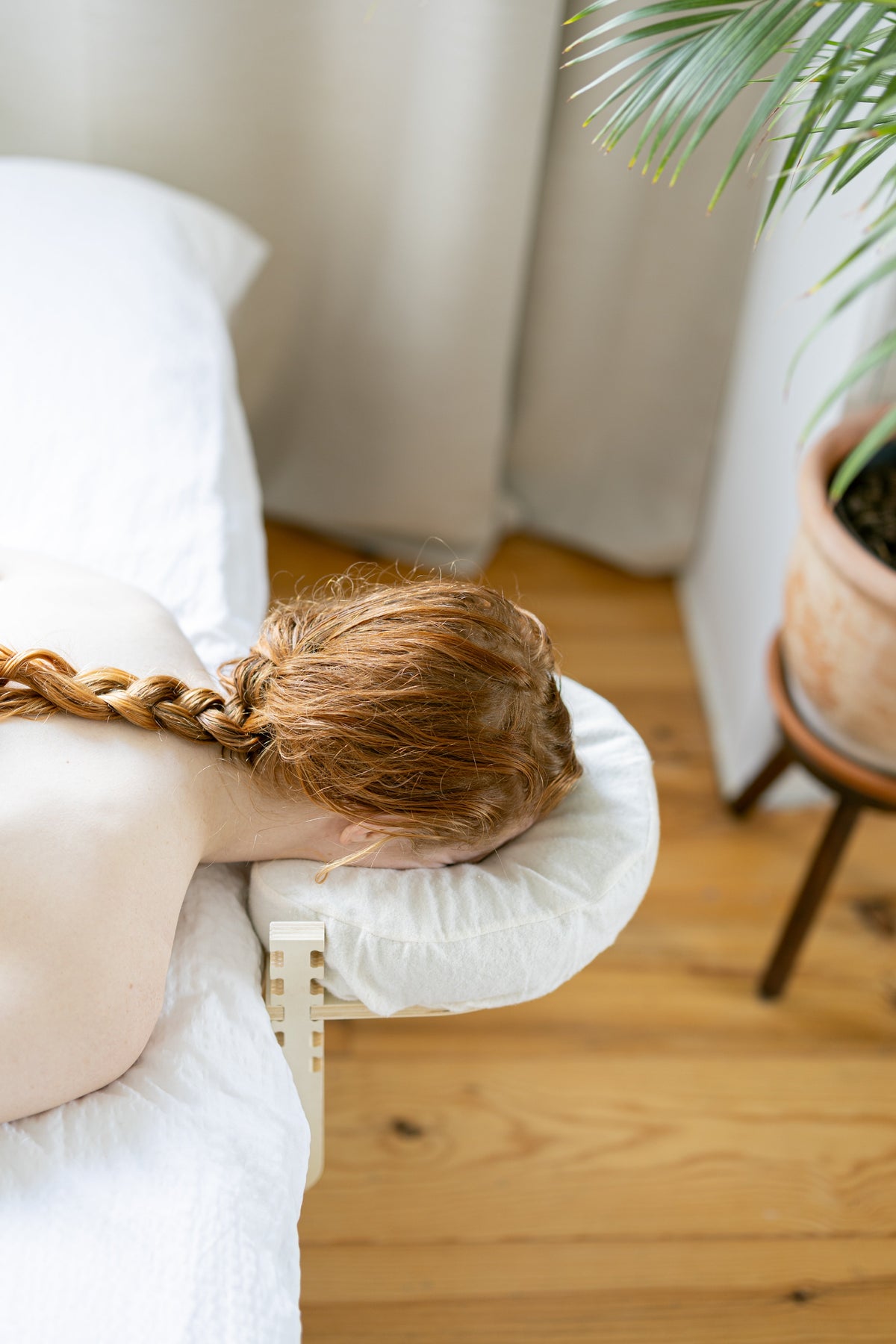 Woman lying with her face in the headrest by the window