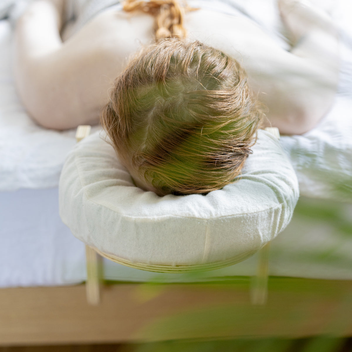 Top view of the head cushion with the cotton cover on the wooden frame
